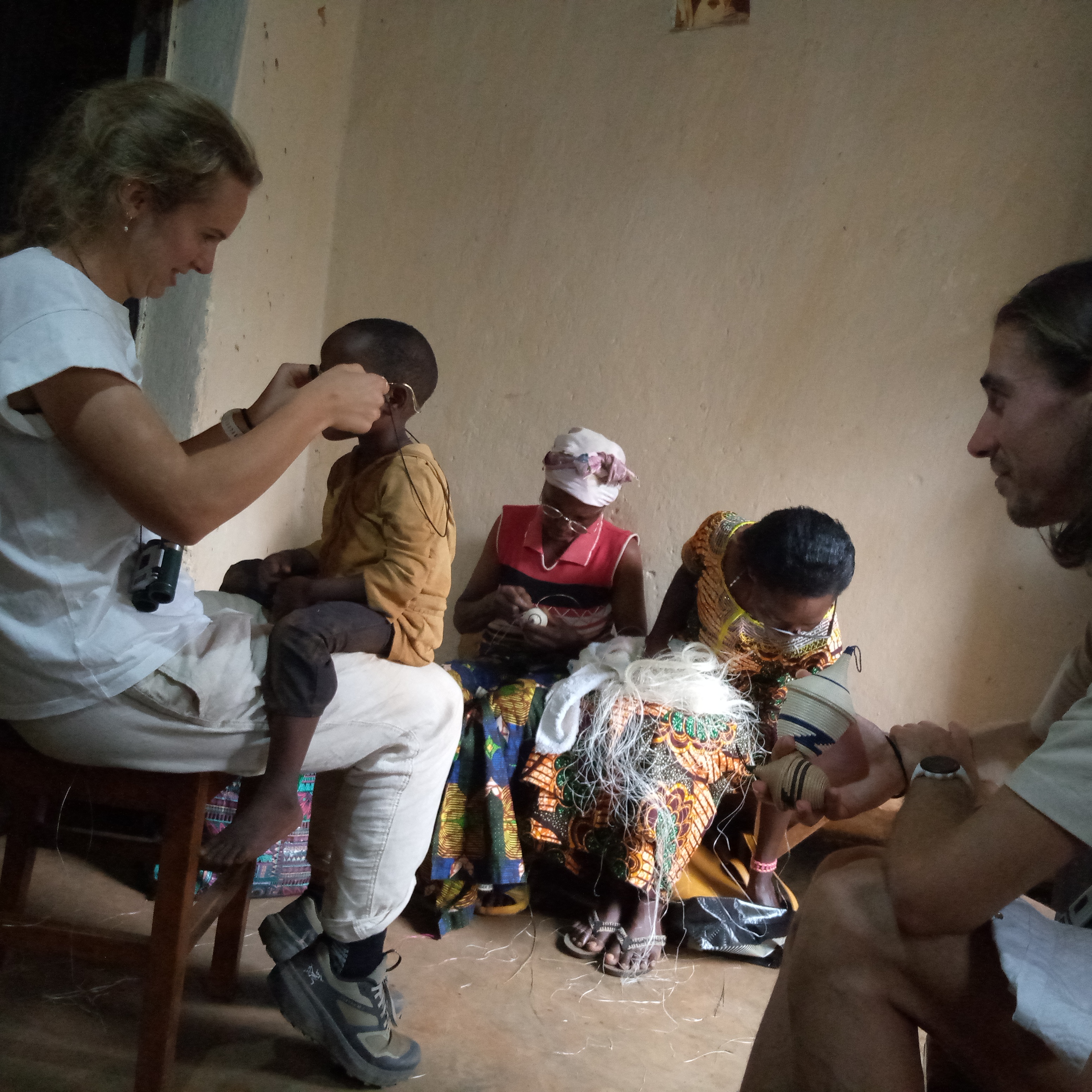 A rwandan men serving food to rwandan children outdoors