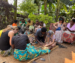 A rwandan man selling traditional 
              vases and decorations outside